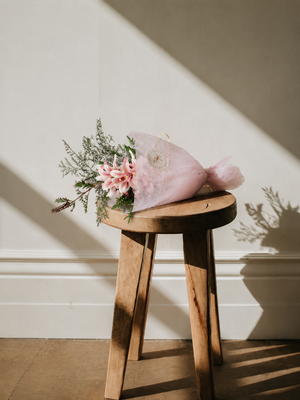A small bouquet and flower bunch under $50 sitting on a bench in Vancouver 