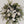 Green and white funeral wreath with stand